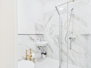 a white bathroom with a shower and a sink at Landeskron38 - LK38 in Görlitz +76 photos