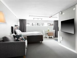 a living room with a bed and a couch at Stockholm Hostel in Stockholm
