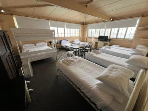 a room with several beds and a table and chairs at The Gordon in Goulburn