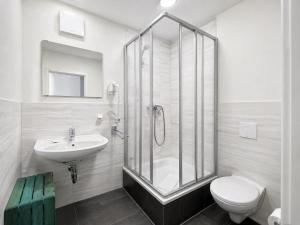 un baño con ducha, inodoro y lavabo en Elbhotel Dresden by AURUM, en Dresden