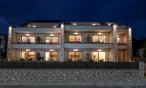 a large white building with lights on it at night at Almondo Suites in Amigdhaleón