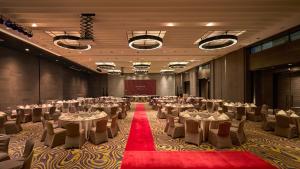 a banquet hall with tables and chairs and a red carpet at Ormond Sandakan in Sandakan +36 photos