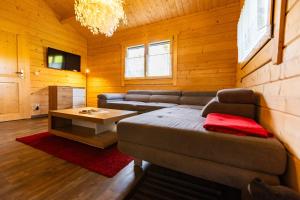 a living room with a couch and a coffee table at Bungalows am Senftenberger See in Großkoschen