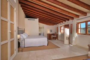 a bedroom with a bed and a desk in a room at Belle Son Mas Luxury Finca Hotel in Porto Cristo +39 photos