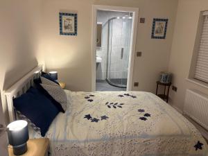 a bedroom with a bed with a blue and white comforter at Cross Winds in Lancaster