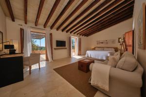 a bedroom with a bed and a living room at Belle Son Mas Luxury Finca Hotel in Porto Cristo