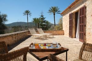 a table with a tray of food on a patio at Belle Son Mas Luxury Finca Hotel in Porto Cristo
