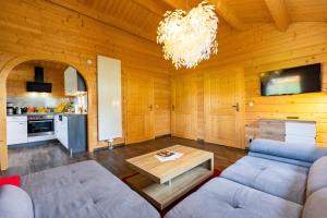 a living room with a couch and a table at Bungalows am Senftenberger See in Großkoschen