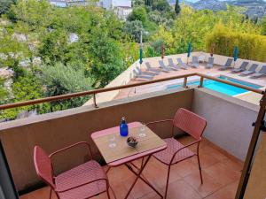 a patio with a table and chairs and a pool at Virginia N101 ST2 in Grasse +2 photos