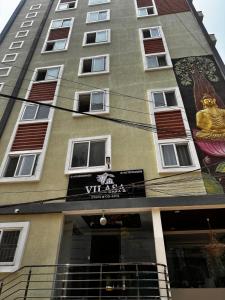 a tall building with a mural on the side of it at Vilasa stays and colive in Hyderabad