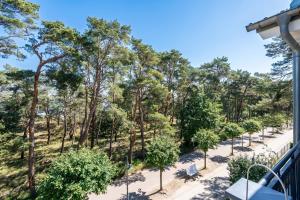 a view from a balcony of a park with trees at Villa Lebensart - App 7 Lebensart in Ahlbeck