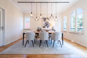 a dining room with a table and chairs at Villa Lebensart - App 7 Lebensart in Ahlbeck +20 photos