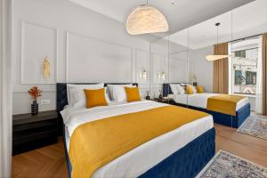 a bedroom with two beds with yellow and blue at King Richards Royal Residence in Dubrovnik
