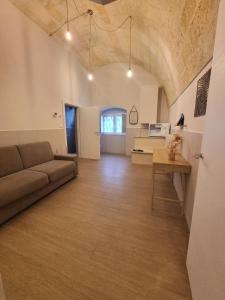 a living room with a couch and a table at B&B Luna Rossa in Altamura