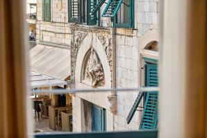 a view from a window of a building with green shutters at King Richards Royal Residence in Dubrovnik +52 photos