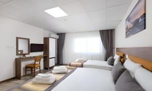 a hotel room with a bed and a desk at River Elite Hotel Spa in Antalya