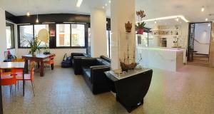 a living room with a couch and a table at Hotel Marbella in Cervia