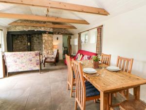 a dining room with a wooden table and chairs at Rhos Y Clegyrn in Goodwick +21 photos