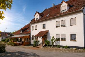 a white house with a brown roof at Ferienwohnungen Stark in Kelheim