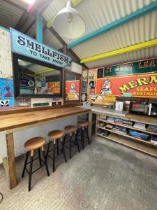 a bar with stools in a baseball restaurant at Allys cute Campervan in Carbis Bay