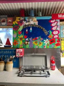 a counter top with a laptop on top of it at Allys cute Campervan in Carbis Bay