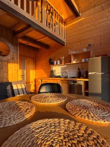 a kitchen with a table with two large wicker seats at Domek z jacuzzi Wypoczynek Pod Lipami in Wólka
