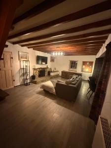 a large living room with a couch and a tv at Lucy Cross Guest House in Lucy Cross