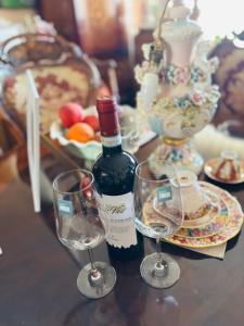 a bottle of wine and two glasses on a table at Experience at Malinova dolina in Sofia