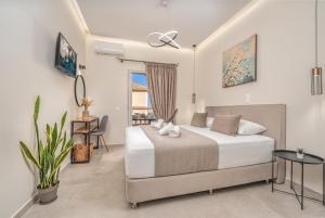 a bedroom with a bed and a table and a chair at Villa Dionysios in Keri
