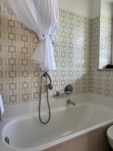 a bath tub in a bathroom with a shower at Garni Rika in Parcines +32 photos