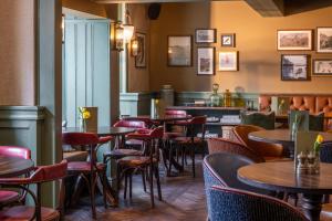 a restaurant with tables and chairs and a bar at Royal Oak at Keswick in Keswick +44 photos