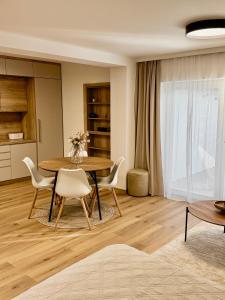 a kitchen and dining room with a table and chairs at Ateliér Smutná in Ostrava