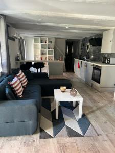 a living room with a blue couch and a table at Stawalters in Kirrwiller