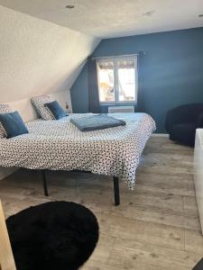 a bedroom with a bed and a window at Stawalters in Kirrwiller