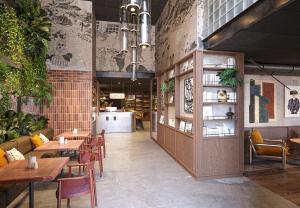 a restaurant with tables and chairs in a room at Hotel Schani Naschmarkt - opening September 2026 in Vienna