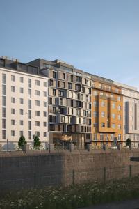 a row of apartment buildings in a city at Hotel Schani Naschmarkt - opening September 2026 in Vienna
