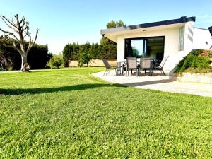 a house with a patio and a grass yard at Villa Escaldes in Montroig +38 photos