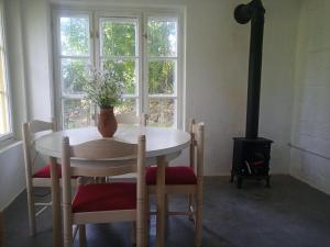 a room with a table and chairs with a stove at Peace House in Esztergom
