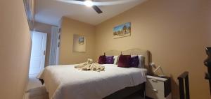 a bedroom with a bed with white sheets and a ceiling at Playa Paraiso-Apartment 4 you in Costa Calma +48 photos