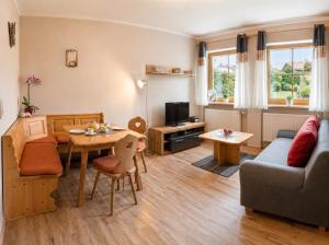 a living room with a couch and a table at Ferienwohnungen Stark in Kelheim