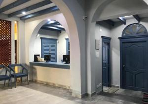 a lobby with a blue door and a counter at Villa Victor in Pondicherry