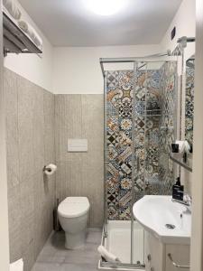 a bathroom with a shower and a toilet and a sink at ALDIVA ROOMS in Torvaianica +61 photos