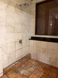 a bathroom with a shower with a window at Brassalova Signature Stay in Port Dickson +6 photos