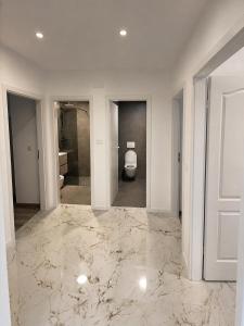 a white room with a toilet and a bathroom at Centrium Makarska in Makarska