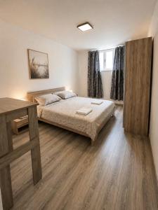 a bedroom with a bed and a desk in it at Centrium Makarska in Makarska