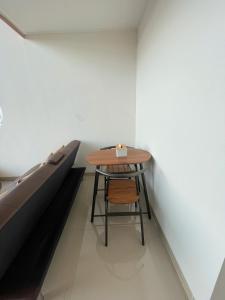a table and a chair in a room with a bed at Villa With Jacuzzi, Damar Ningrum 3 in Tutugan