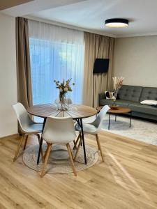 a dining table and chairs in a living room at Ateliér Smutná in Ostrava