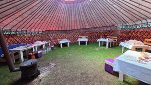 a gazebo with tables and a red roof at Emin Sky Camp in Mineralʼnyy Istochnik Altyn-Arasan
