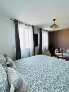 a bedroom with a large bed in a room with windows at Downtown High Standing Duplex - "CENTRUM" in Épernay