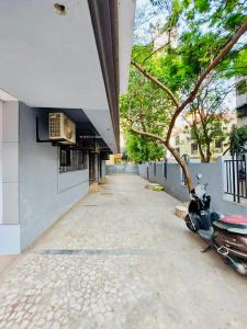 a scooter parked on a sidewalk next to a building at Kalpataru Hometel in Mumbai